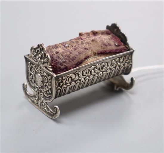 A late Victorian novelty repousse silver mounted cradle pin cushion, Saunders & Shepherd, Birmingham, 1896, 59mm.